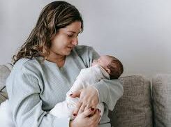 Woman smiles at her baby