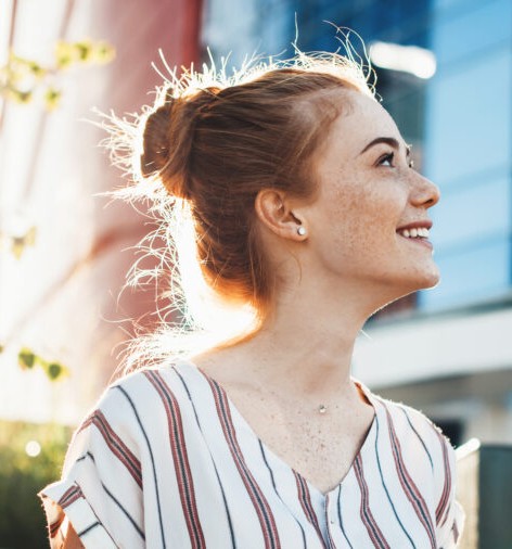 A happy girl looks up.